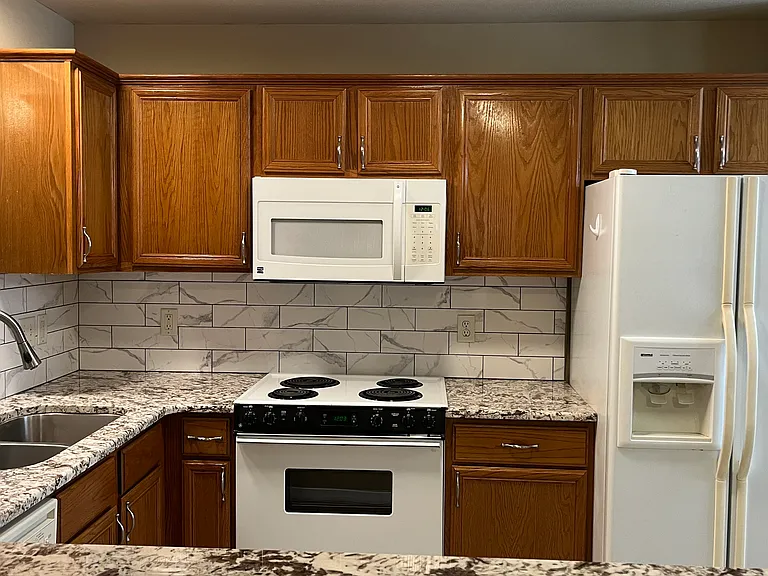 kitchen with updated countertops and back splash