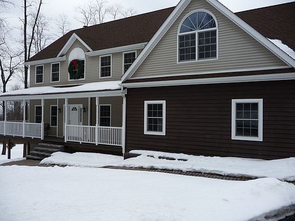 Front of the house with new walkway and new clapboard in front of garage
