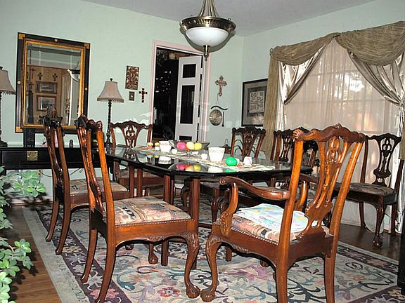 Formal dining opens to the entry and has a wonderful view of the large front yard.