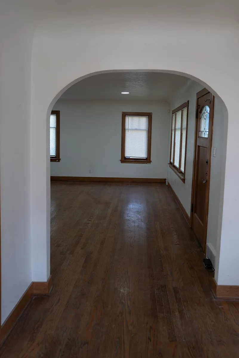 Looking into the living room from the dining room, front door on the right. - 2613 S 122nd St