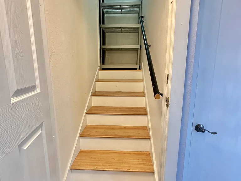 Interior pantry/storage. Walkway is blocked off to upper unit by permanently locked door and sound dampening insulation panels.