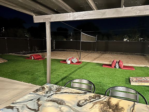 Covered patio and patio furniture is provided for enjoyment.