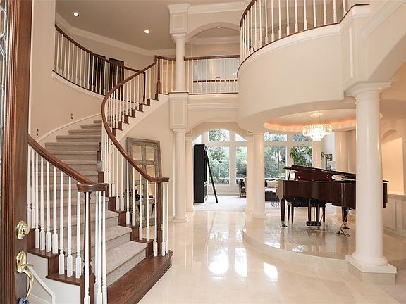 THE VIEW AS YOU ENTER THIS GRAND HOME IS ENTICING - COME...TAKE A LOOK - An amazing wide foyer welcomes you into this custom home built with design and function in mind. The spiral staircase to the left with circular upstairs balcony are a dream for 