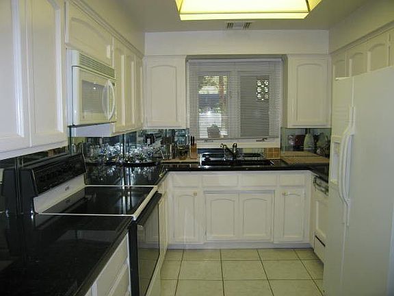 Granite counters and tile floor in kitchen