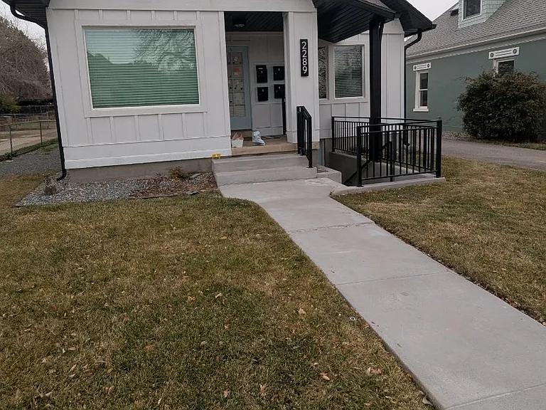 Exterior of triplex. Separate entry to Unit #2 to right of porch.