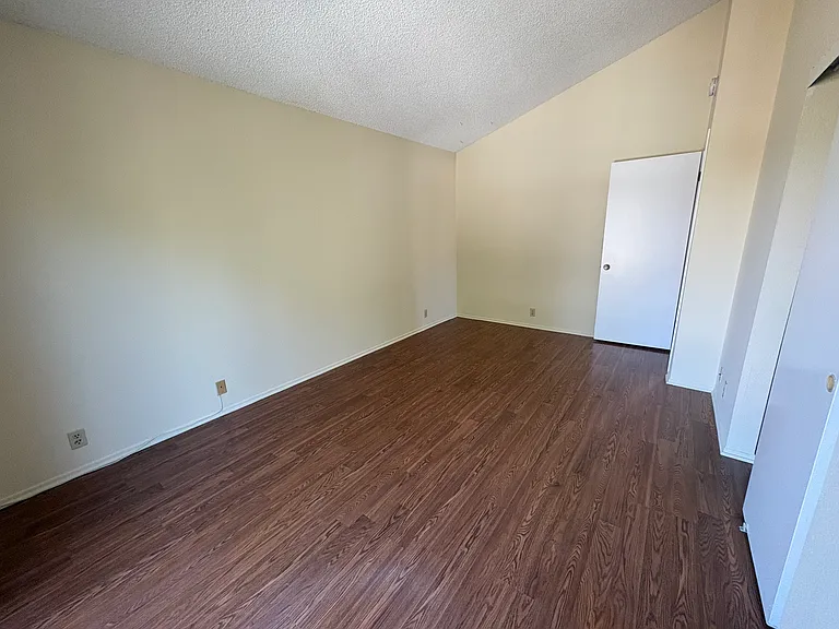 Huge bedroom with cathedral ceiling and slider to private balcony