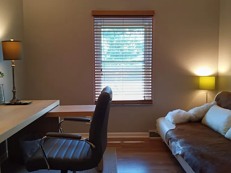Additional large room converted into functioning office with full desk workspace, ergonomic chair, EPSON WF printer and comfy seating for taking a break