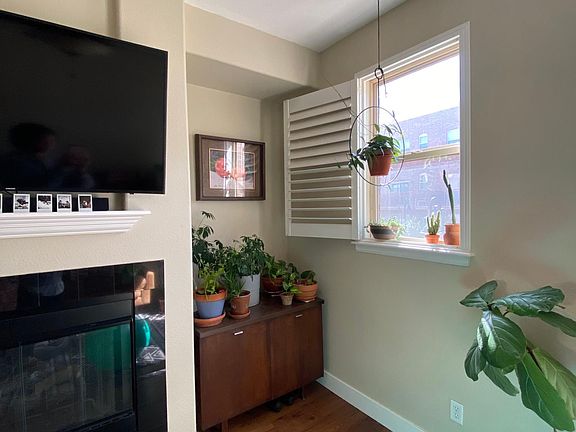 Living room space perfect for a liquor cabinet, plant stand, or bookcase