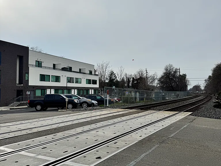 Railroad tracks and Electric Vehicle charging stations across from the property.