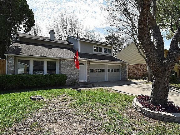 Big front yard with large shade tree.