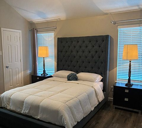Main suite with a ceiling fan, walk-in closet and bathroom with shower.