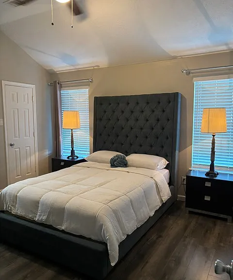 Main suite with a ceiling fan, walk-in closet and bathroom with shower.