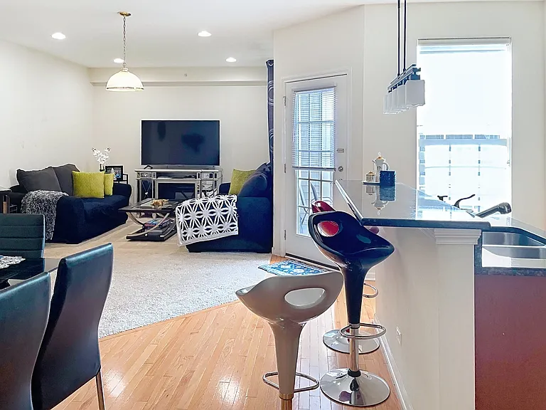 View at the family room, kitchen and breakfast area with the door to the backyard patio