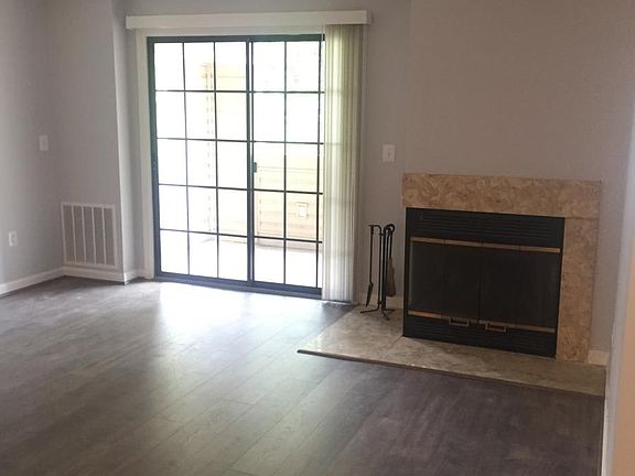 Main Hall with fireplace and sliding doors to porch.