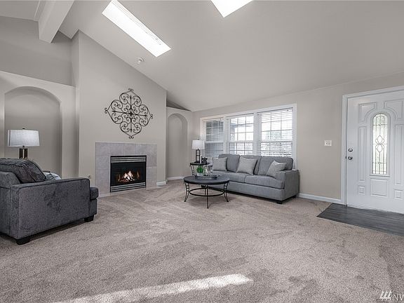 Love the vaulted ceiling, skylights & art niches...