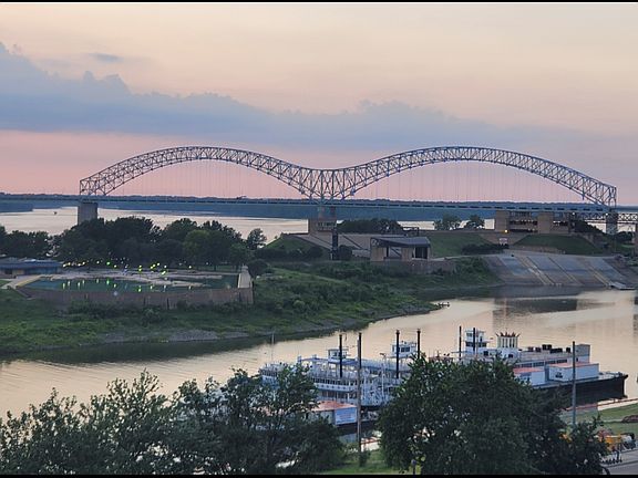 View of the Hernando DeSoto bridge and riverboats from the balcony