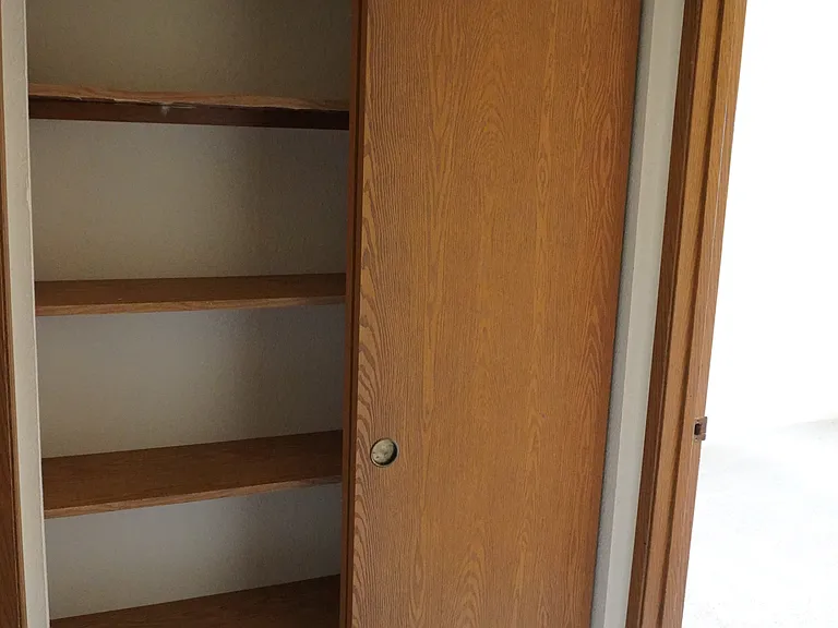 Hallway closet between secondary bedrooms
