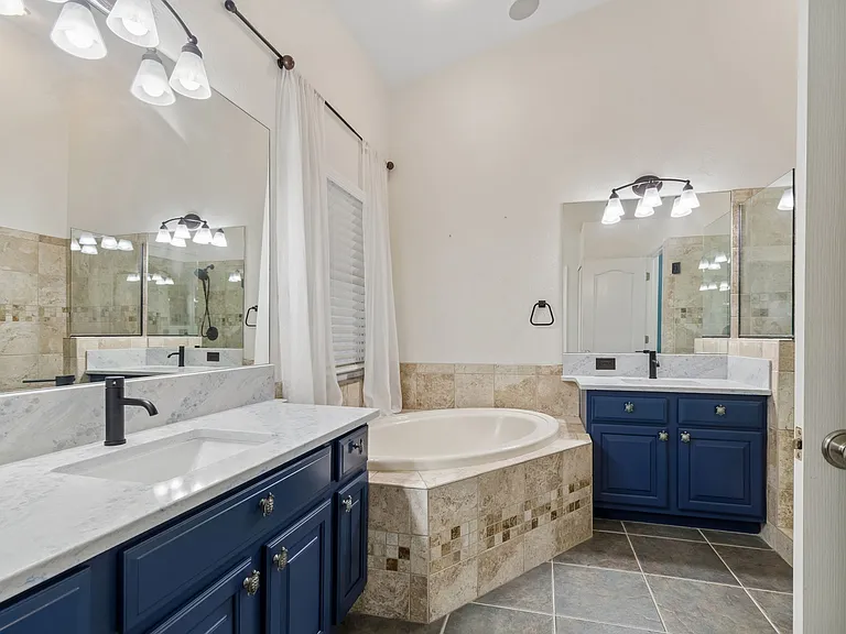 Luxury, timeless and beautiful Primary Bathroom with separate walk-in shower, separate toilet room, soaking tub and dual beautiful vanities