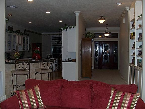 Looking from the living area into the kitchen and wide hallway to the front entry.