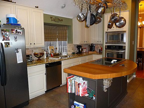 Kitchen with Stainless Appliances and Title Flooring