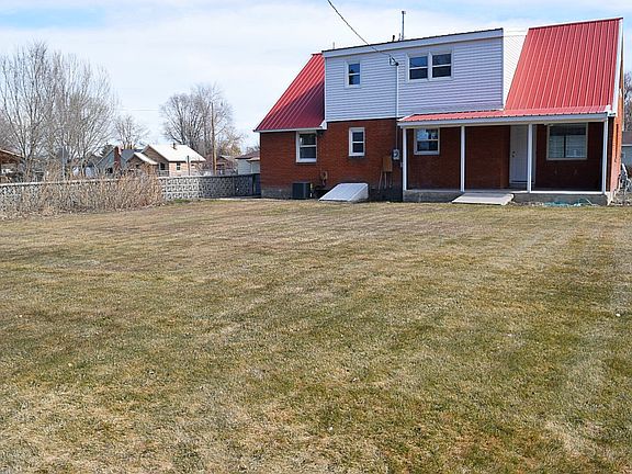 back of home with porch