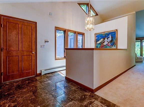 Foyer.   Vaulted ceiling and solid wooden doors.
