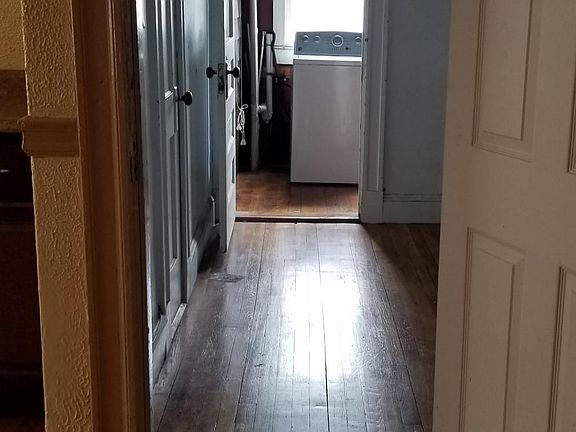 Back hall off kitchen to enclosed porch with laundry hook up and back stair way to back yard parking area and trash disposal