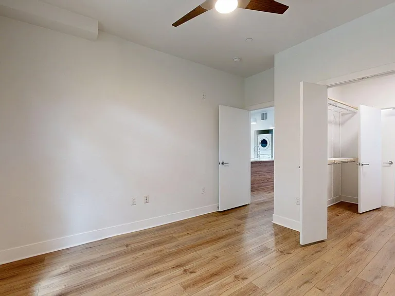 Spacious apartment Bedroom with Attached Bathroom and wood-style flooring