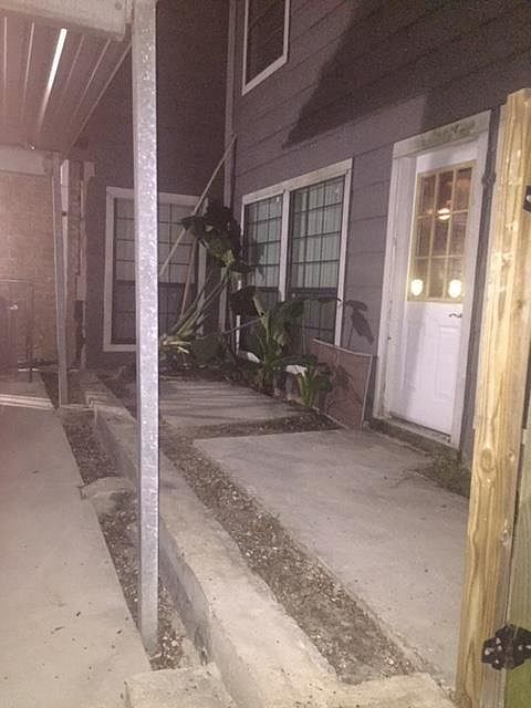 Front door with new fence being installed around private pat