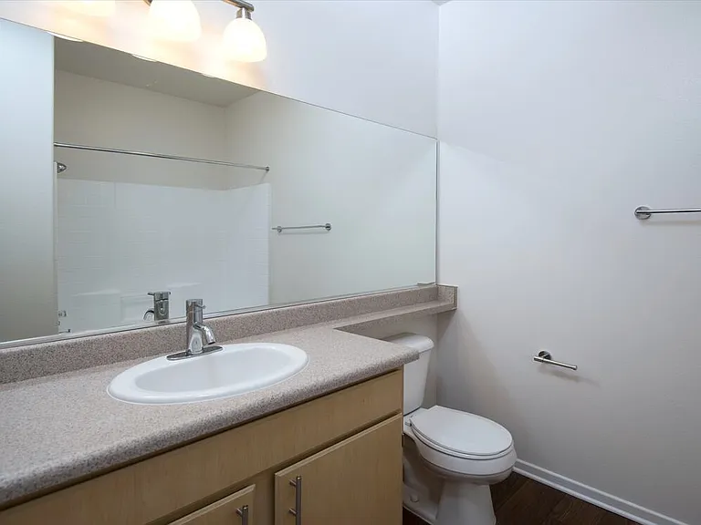 Classic Package II bath with laminate countertops, oak cabinetry, and hard surface flooring