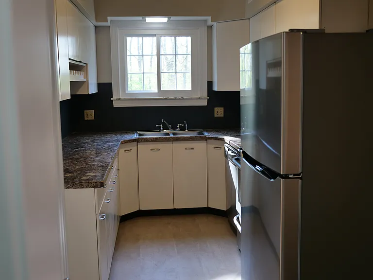 Spacious kitchen with new flooring and brand new fridge.