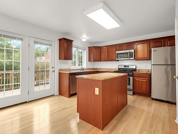 Kitchen with granite and stainless steel appliances.