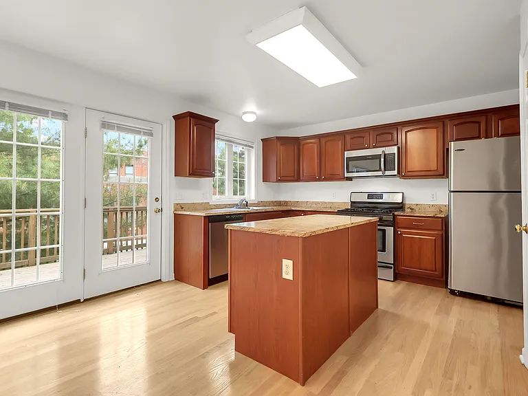 Kitchen with granite and stainless steel appliances.