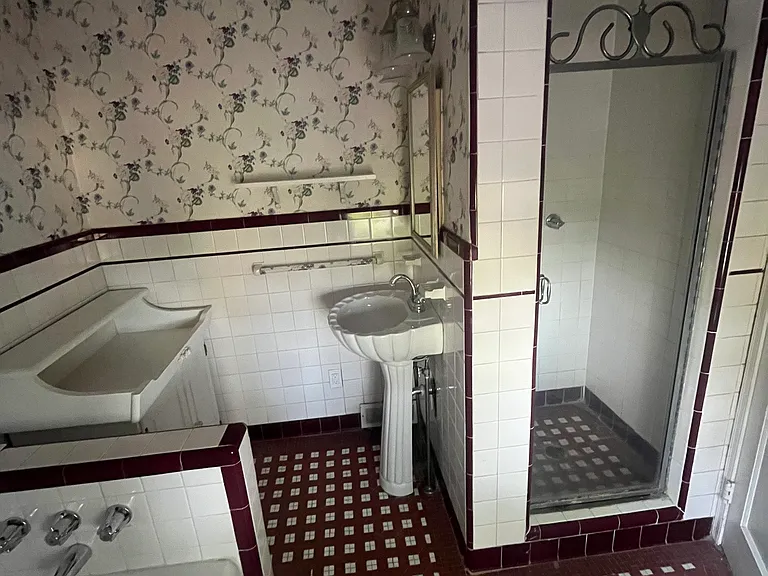 One full bathroom with soaking tub & stall shower, one pedestal sink