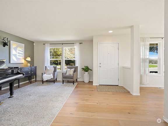 Looking towards the front entry, with the living room to the left and the dining room to the right. >