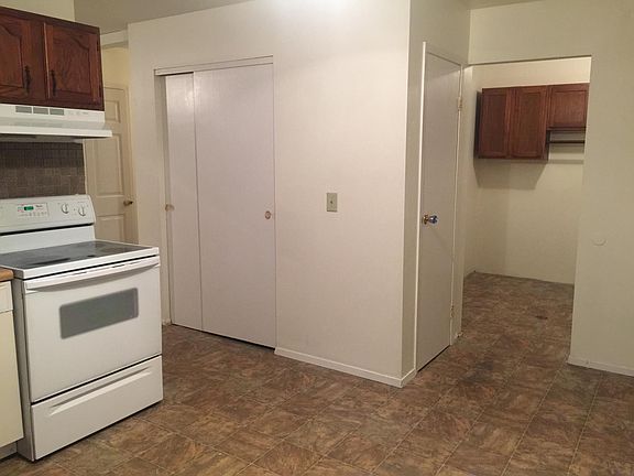 Laundry room with cabinets off of eat-in kitchen