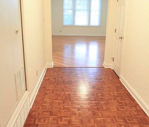 Formal Entrance & Foyer featuring parquet wood floors and ar