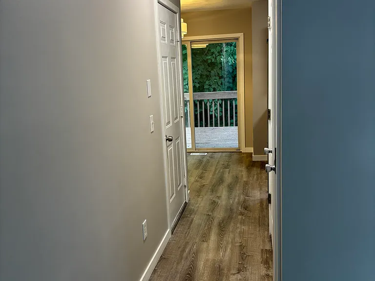 Hall from Livingroom to Dining/Kitchen, 1/2 Bath, and 1 Car Garage