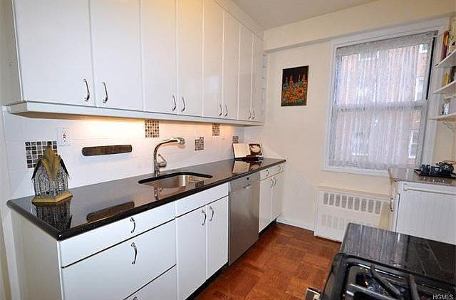 Updated Kitchen with granite counters and stainless steel dishwasher, microwave, stove.  There is a French door refrigerator. custom cabinets and decorative tile back splash.