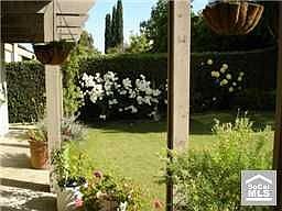 Large yard with beautiful gardens 