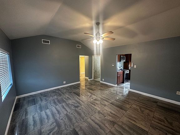 Living rooms showing restroom and hallway to the 2 bedrooms.