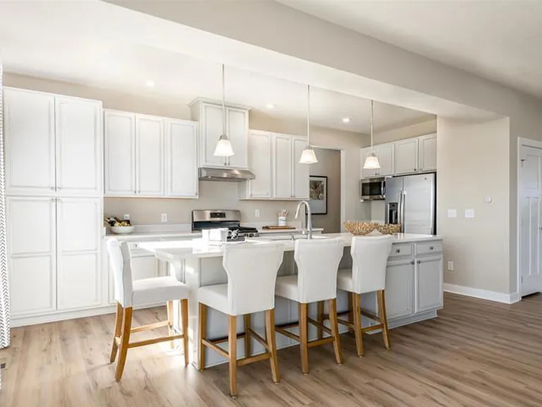 Open Kitchen with White Cabinets and Granite Counter Top Stainless Steel Appliances
