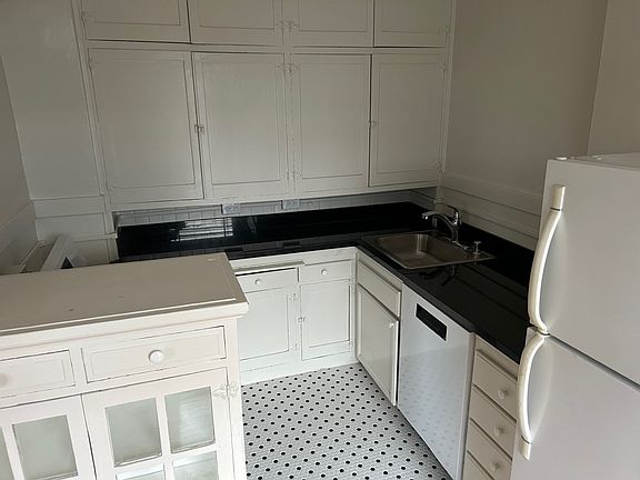 Kitchen with new stove, dishwasher and tile floors