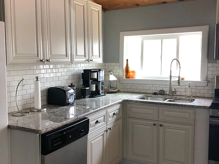 Kitchen has a gas stove , microwave and dishwasher