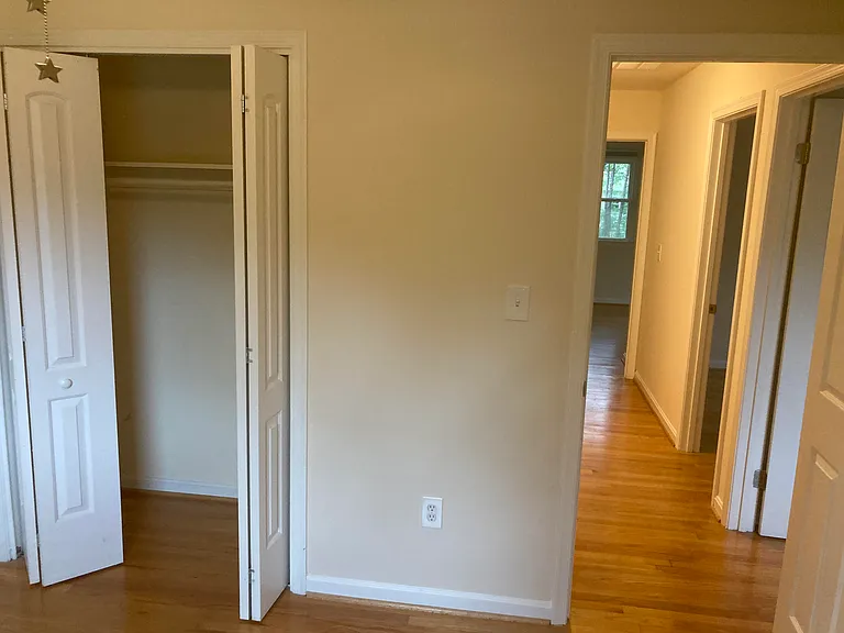 View from upstairs painted room closet, with door leading to two bedrooms and master suite on opposite end.