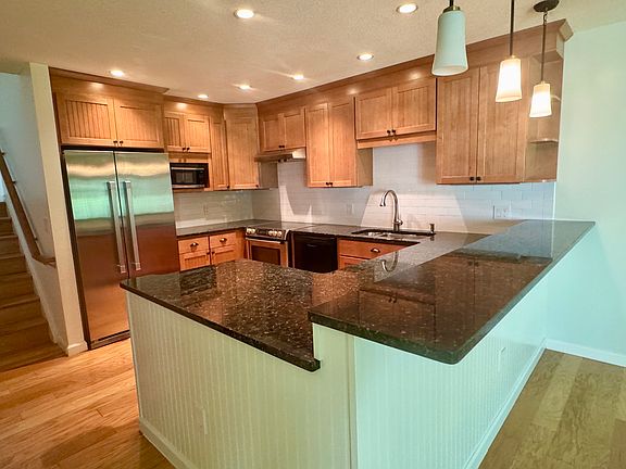 Kitchen view with granite topped counters and breakfast bar