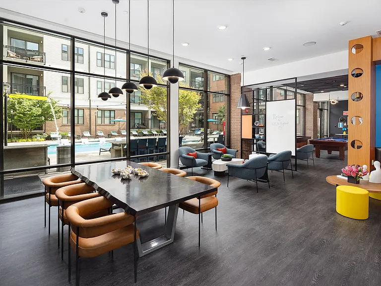 Community Lounge with Meeting Table, Lounge Seating, and Pool Views