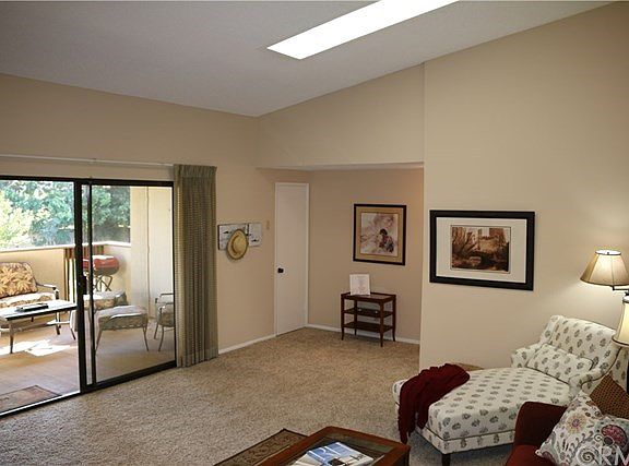 Living Room view to Covered Veranda overlooking the Greenbelt.