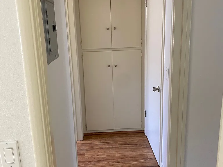 hallway with storage closet and coat closet