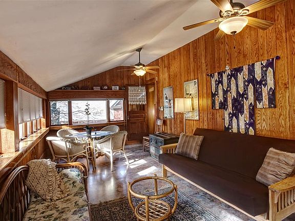 View of the sun-room with futon and dining table.